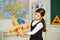 Small girl play with toy airplane. Child pilot aviator with airplane dreams. retro wooden toy in modern education. fly