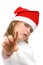 Small girl in Santa hat pointing finger at camera