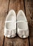 Small girl silver ballet shoes on vintage rustic wood