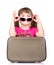 Small girl with sunglasses and suitcase. isolated on white