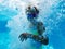 Small girl surrounded by bubbles inside of swimming pool