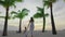 Small girl walking with mother at tropical beach on slow motion video. Sunset in the background