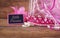 Small girls party outfit: crown and wand flowers next to small chalkboard with phrase LITTLE PRINCESS: on wooden table