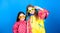 Small girls in raincoat and glasses. happy small girls in colorful rain coat. rain protection. Rainbow. autumn fashion