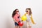 Small girls with sunglasses and balloons standing in a studio.