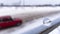 In a small glass ball, calmly standing on the railing in the snow, a silhouette is reflected with a fast drift racing car in the w