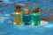 small glass bottles with colored oils stand on a worn blue table