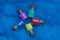 Small glass decorative bottles with colored sand on blue woolen fabric