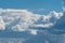 A small glider in front of giant clouds after storm. The clouds break open and blue sky appears