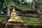 Small golden Buddha statue on the old brick wall of Wat Phutthaisawan,Sampao Lom subdistrict, Phra Nakorn Sri Ayutthaya,Thailand.