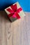 Small golden gift box with red ribbon