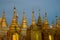 Small golden stupas of the Shwedagon Pagoda in the evening twilight, Yangon