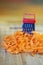 A small grater and a large carrot on a cutting board, in the kitchen. Optical illusion. Close-up. Shallow depth of field