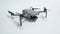 Small gray folding quadcopter with three-axis gimbal camera