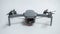 Small gray folding quadcopter with three-axis gimbal camera