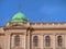 Small green dome and facade of parlament building