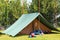 Small green scout tent on a lawn