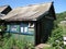 small green wooden board country house in the village in the Russian remote places, Oktyabrsky, Bashkiria, Russia