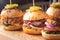 Small grilled burgers served to share on rustic table