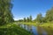 A small group of cyclists on the canal on a summer day