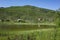 Small group of houses on green hill next to lake in Swedish Lapland. Arctic nature of Scandinavia