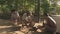 Small group of men sawing and cutting lumps of wood to make mallet heads