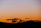 A small group of tourists during a camel trekking at sunset through the Erg Chebbi Dunes.