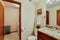 Small guest Bathroom with wood vanity and open door