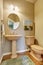 Small half bathroom with hard wood floors.