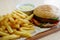 Small hamburger, french fryes and bowl of souse