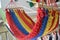 Small hammock made of fabric, wood with striking red, yellow and blue colors with blurred background