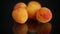 Small handful of ripe apricots on black background