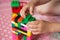 Small hands of the child collects the bright plastic colored Designer. Educational toys and Early learning