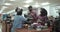 A small and happy family is making payment transactions in front of a supermarket cashier