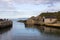 The small harbor at Ballintoy on the North Antrim Coast of Northern Ireland with its stone built boathouse on a day in spring