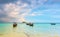 Small harbor with long tail boats at Ko Lipe island, Thailand, shortly before tropical storm. Big and heavy dark clouds above sea