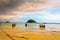 Small harbor with long tail boats at Ko Lipe island, Thailand, shortly before tropical storm. Big and heavy dark clouds above sea