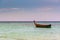 Small harbor with long tail boats at Ko Lipe island, Thailand, shortly before tropical storm. Big and heavy dark clouds above sea