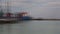 Small harbor panning to industrial ship,editorial