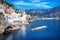 Small haven of Amalfi village with white houses, located on the rock, Amalfi coast, Italy