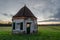 Small hexagonal house in the middle of the field