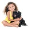 Small hispanic girl hugging her pet dog