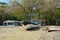 Small house, boat and trees on sandy beach