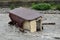 A small house destroyed the mudflow in the mountains. A small house was washed away by a flooded mountain river