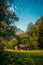 Small house found near a forest and a haystack near the house ag