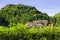 Small house hide under shadow of hill in the forest.