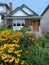 small house with lush front garden