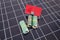 Small house model and Australian dollar banknotes on solar panels background