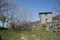 Small house in the mountains abandoned in a large green clearing on the Apuan Alps in Tuscany, Tuscan Apennines