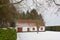 Small house in nature with snow in the flemish countryside